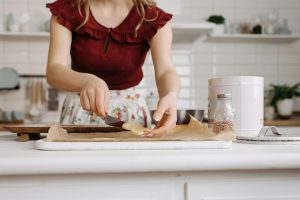 A woman enjoying baking at home with Watkins Canada organic spices and vanilla.